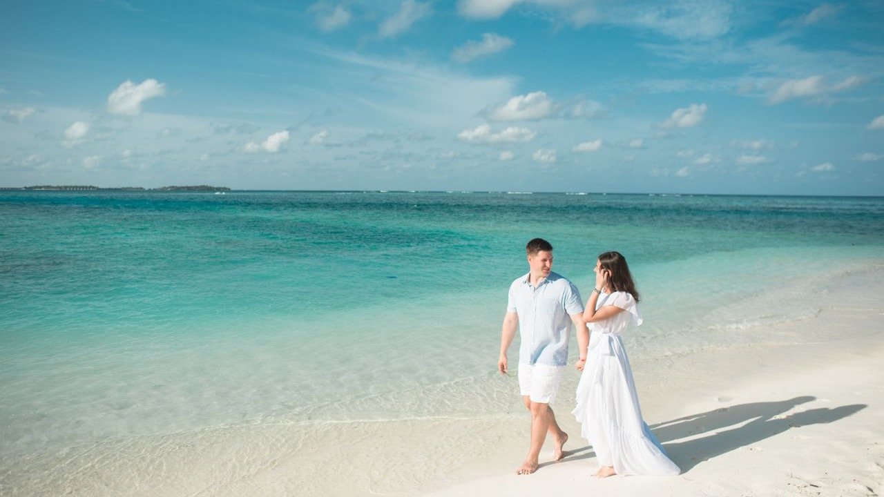 Couple walking along a tropical beach