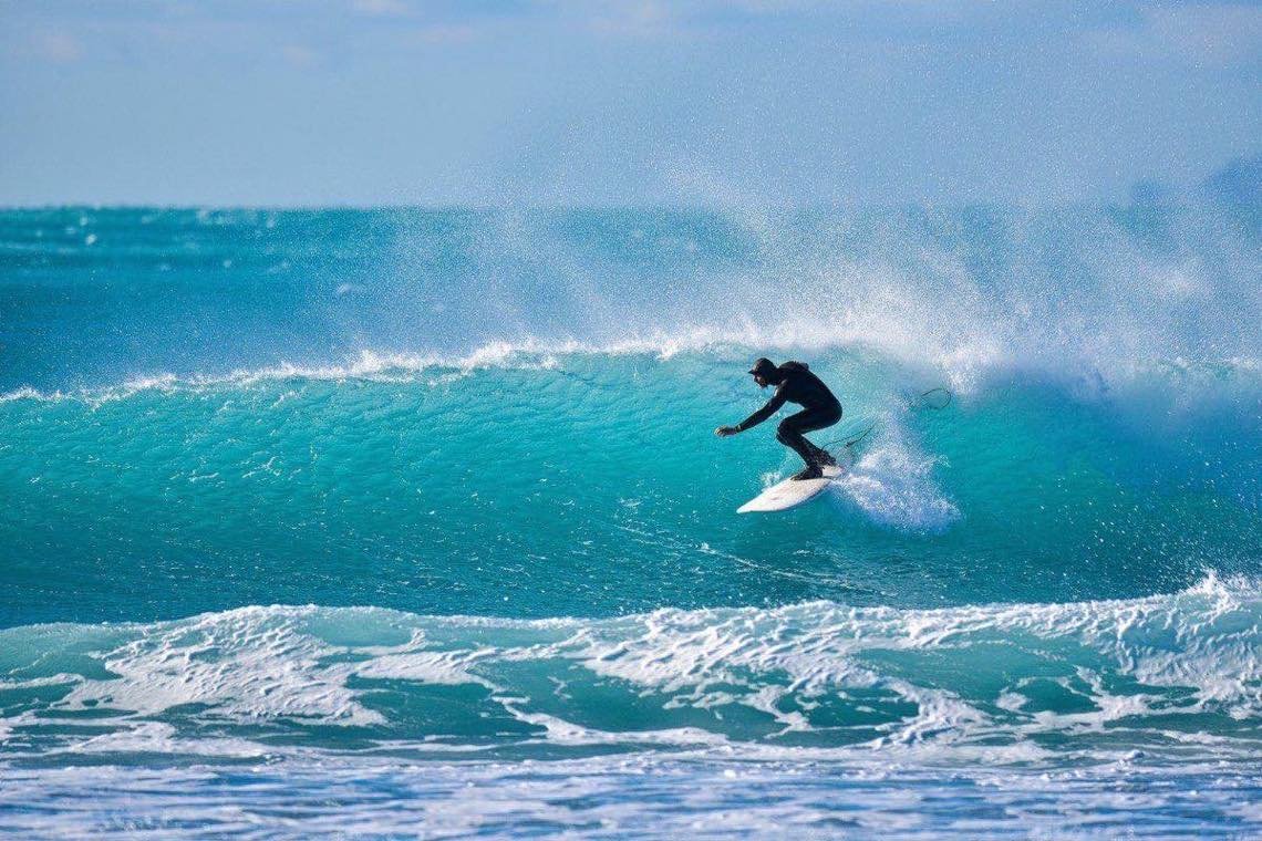 Surfers in Sri Lanka at sunset